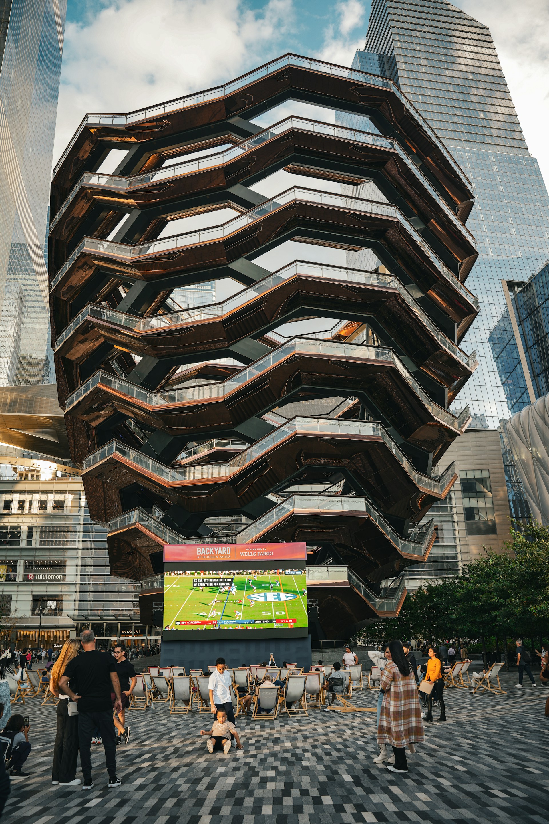 woman wearing yellow long-sleeved dress under white clouds and blue sky during daytime