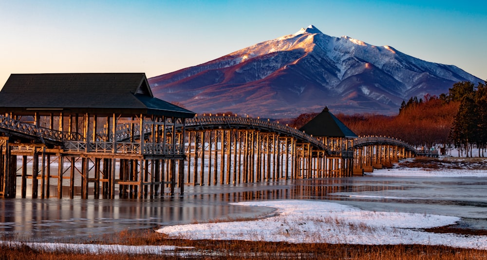a wooden pier with a mountain in the background