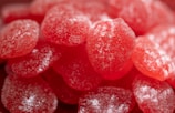 Close-up of spicy gummy candies coated with chili powder.