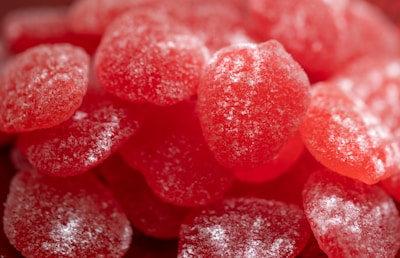Close-up of spicy gummy candies coated with chili powder.