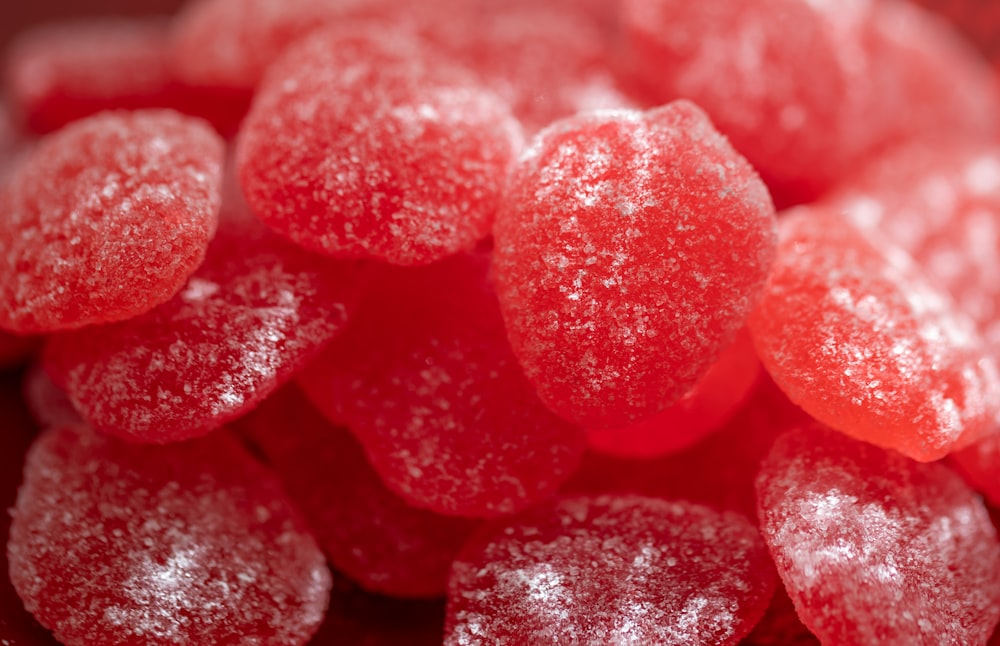 a close up of a pile of red candies