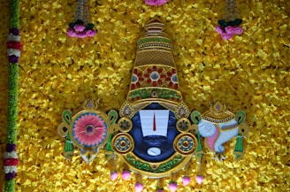 A serene image depicting Lord Krishna surrounded by floral decorations.