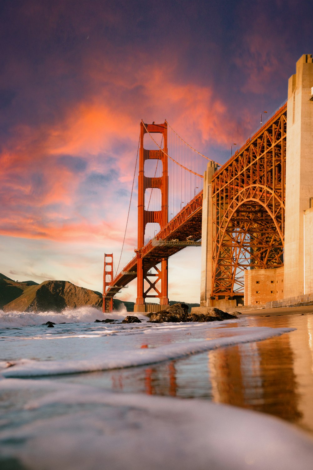the golden gate bridge is reflected in the water