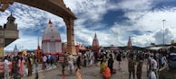 Wide shot of the temple courtyard bustling with visitors during a festival.