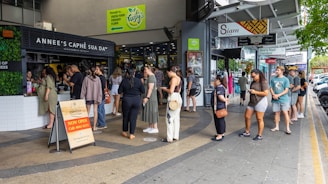 a group of people standing outside of a store