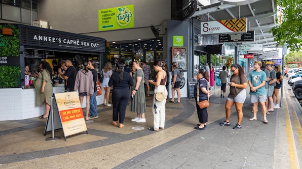 a group of people standing outside of a store