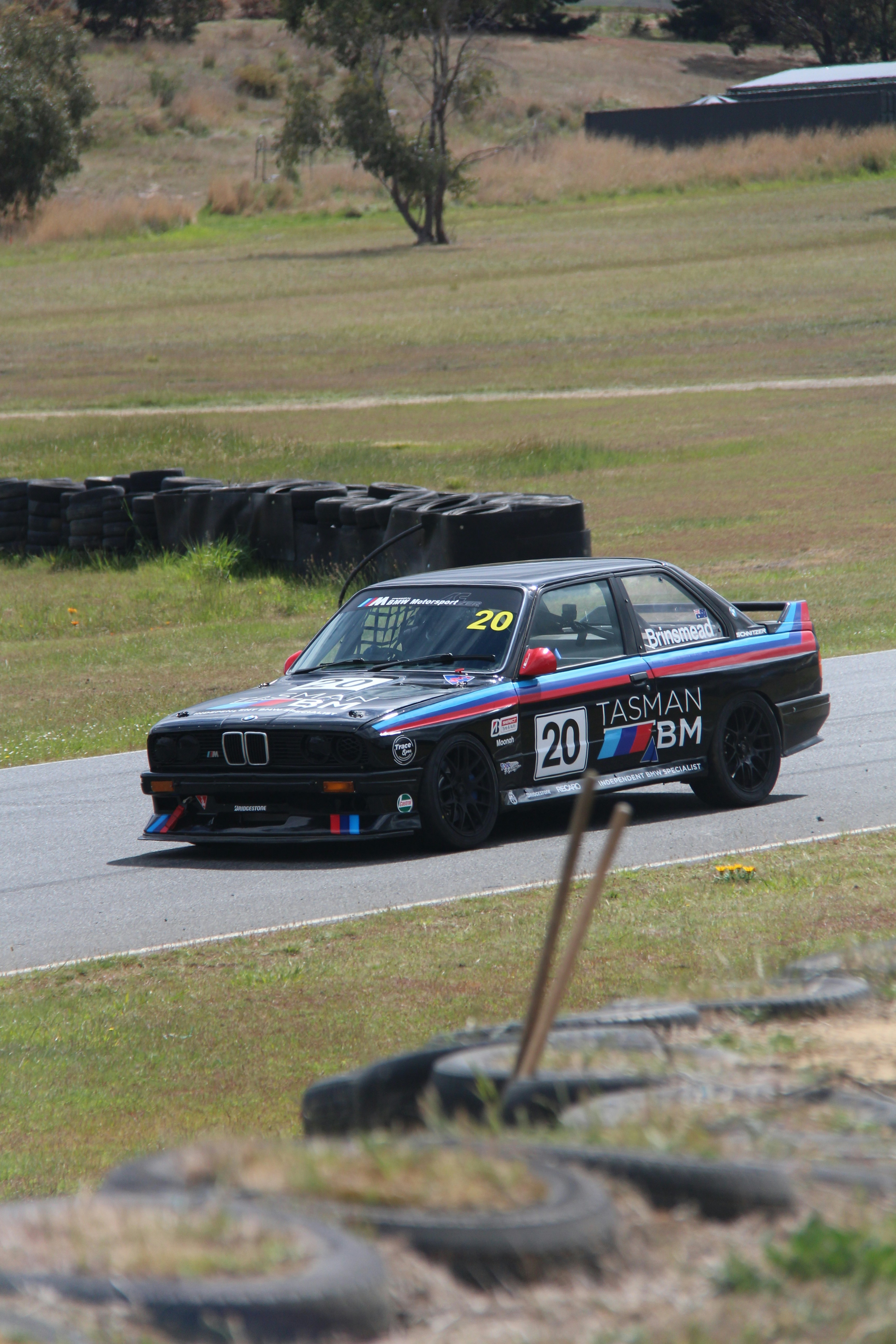 A bmw race car driving down a race track photo – Free Car Image on Unsplash