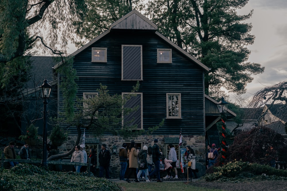 a group of people standing in front of a house