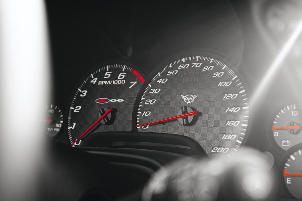 a close up of a speedometer and gauges in a car