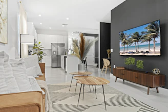 A modern living room featuring Talpa's smart bed, recliner, and coffee maker with minimalist decor.