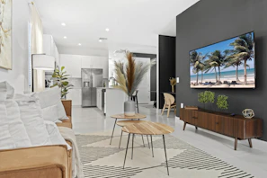 a living room filled with furniture and a flat screen tv