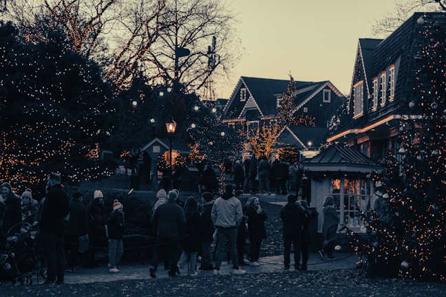 Smiling villagers gathered around newly installed electric lights in their homes.