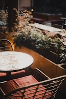 An elegant outdoor mosaic table surrounded by lush greenery.