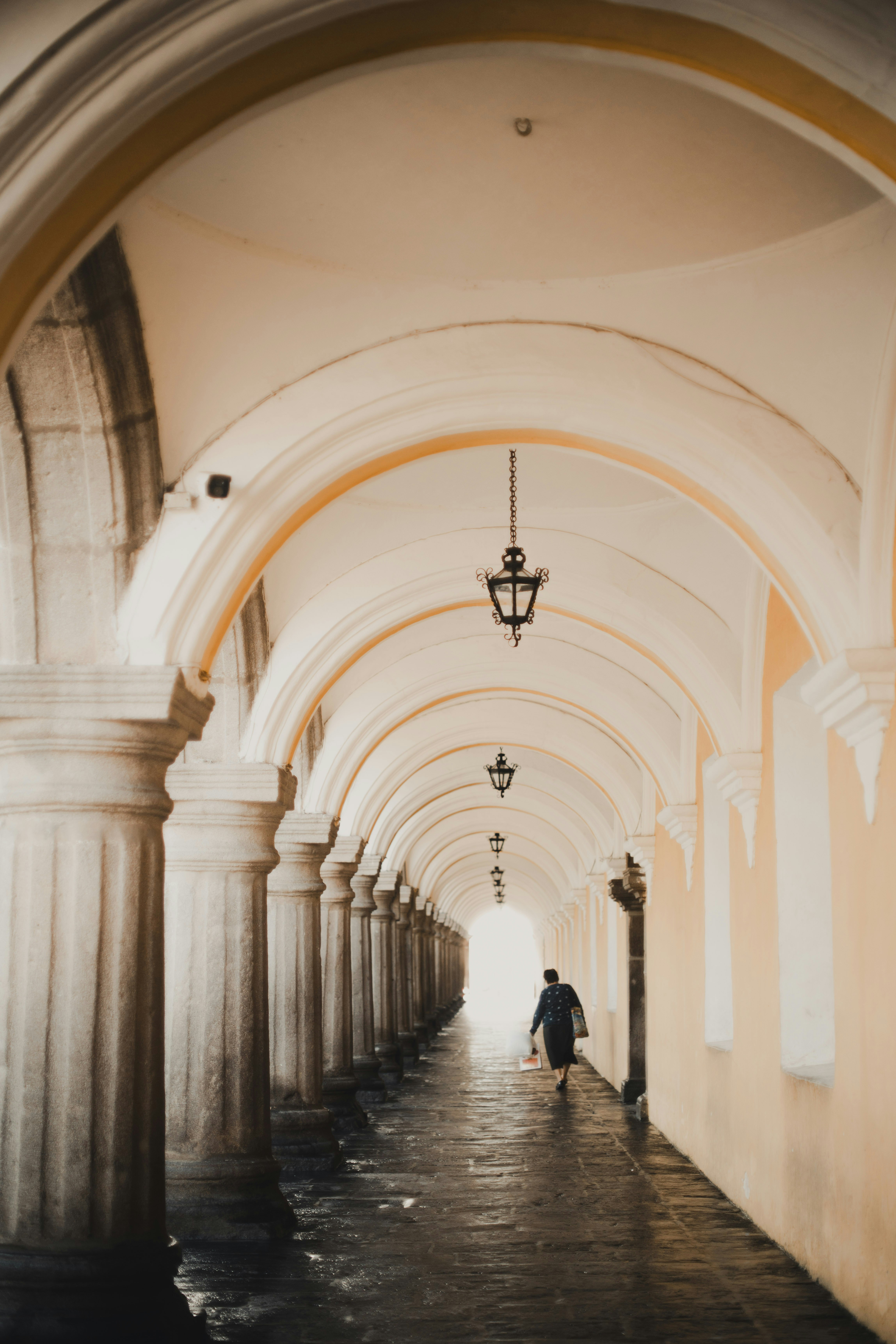 a man is walking down a long hallway