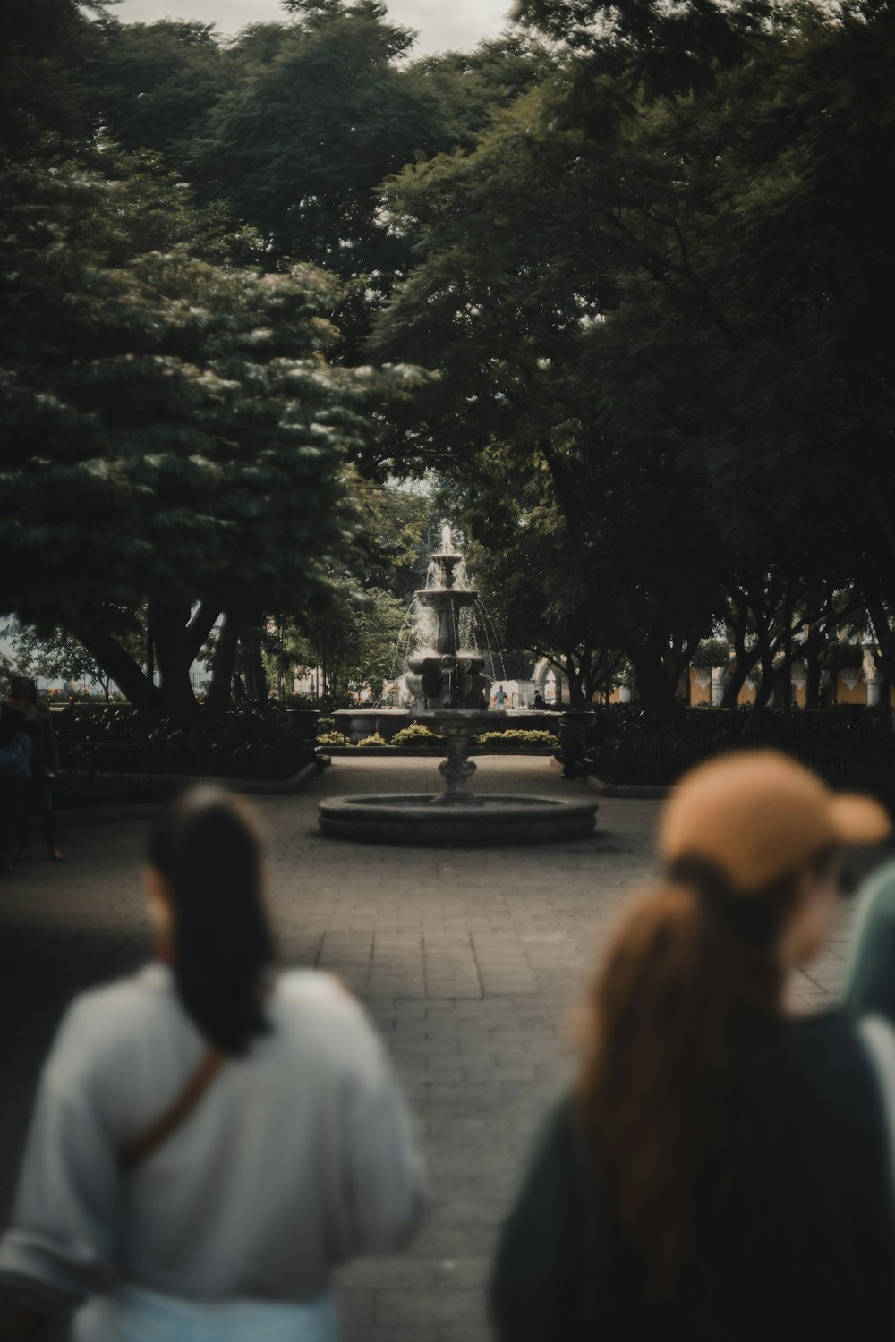 a group of people standing around a fountain