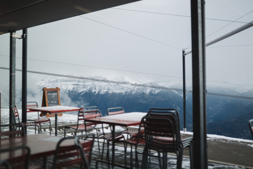 a table and chairs with a view of a mountain