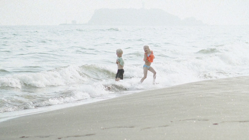 a couple of people that are standing in the water