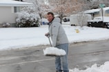 Jason Frost clearing snow from a residential driveway in Spring Creek.