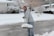 A friendly worker shoveling snow on a residential driveway in Port Coquitlam.