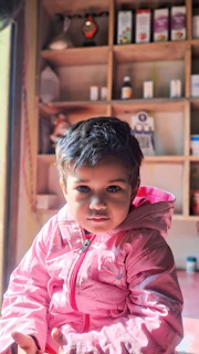 A calm scene of a child gently exploring a nature activity box at home.