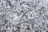 A textured surface featuring a gray, speckled pattern typical of stone or concrete. The irregular shapes and shades of gray create a natural, rugged appearance.