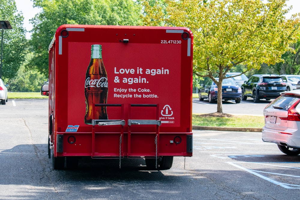 a coca - cola truck is parked in a parking lot