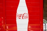 a coca cola sign painted on the side of a building