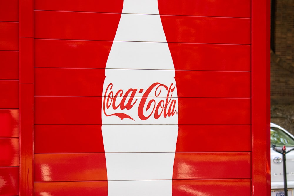 a coca cola sign painted on the side of a building