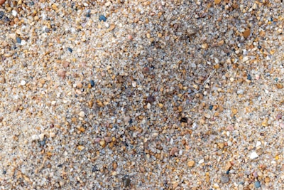 Close-up of various construction aggregates like sand and gravel in a pile.