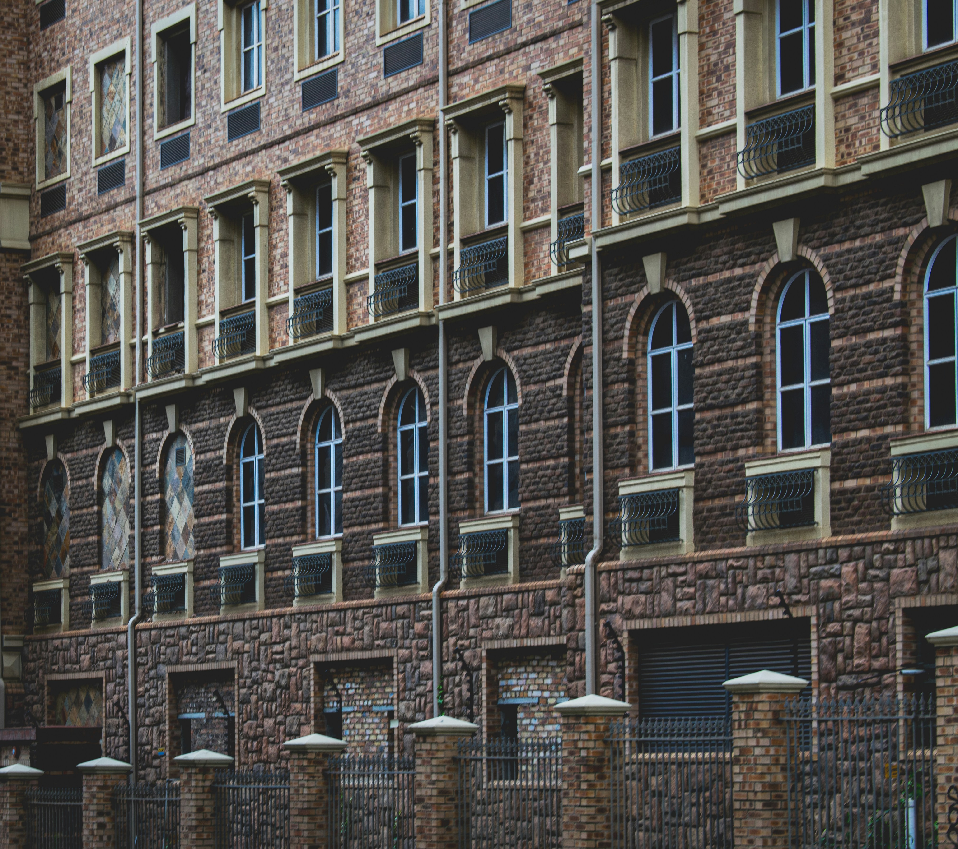 a large brick building with many windows and a clock