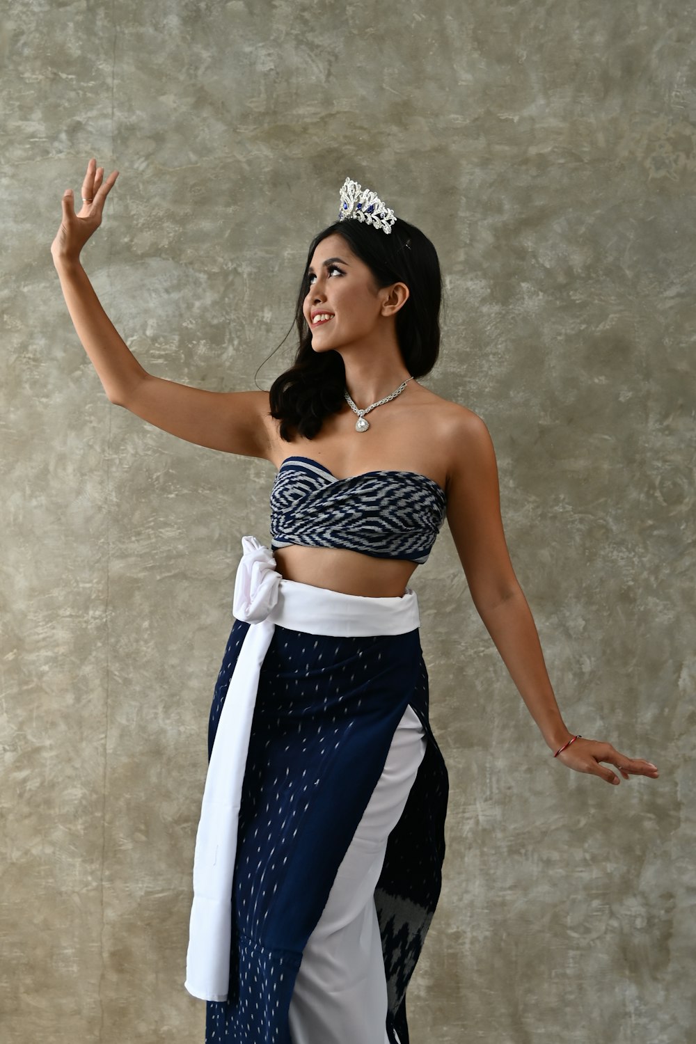 a woman in a blue and white outfit with a tiara