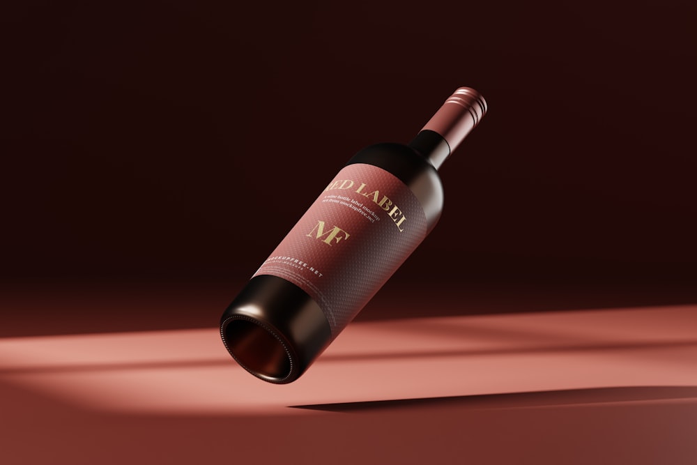 a bottle of wine on a red surface