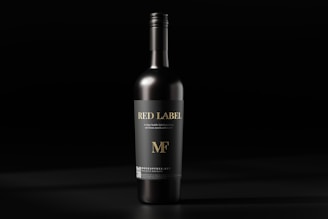 a bottle of red wine on a black background