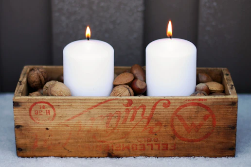 Rustic gift box with handmade candle and avocado honey jar on wooden table at sunset in Axarquía.