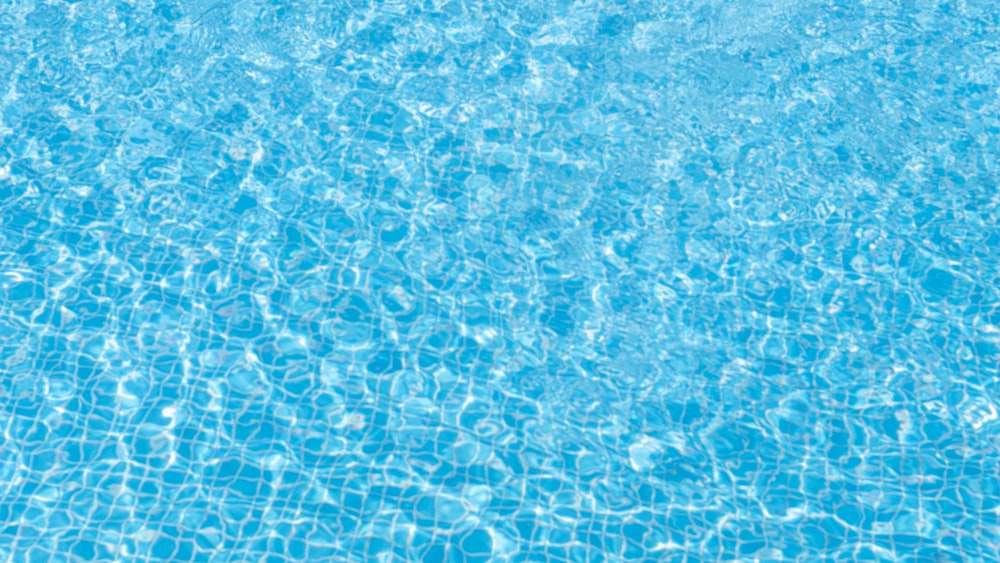 a swimming pool with blue water and a blue sky