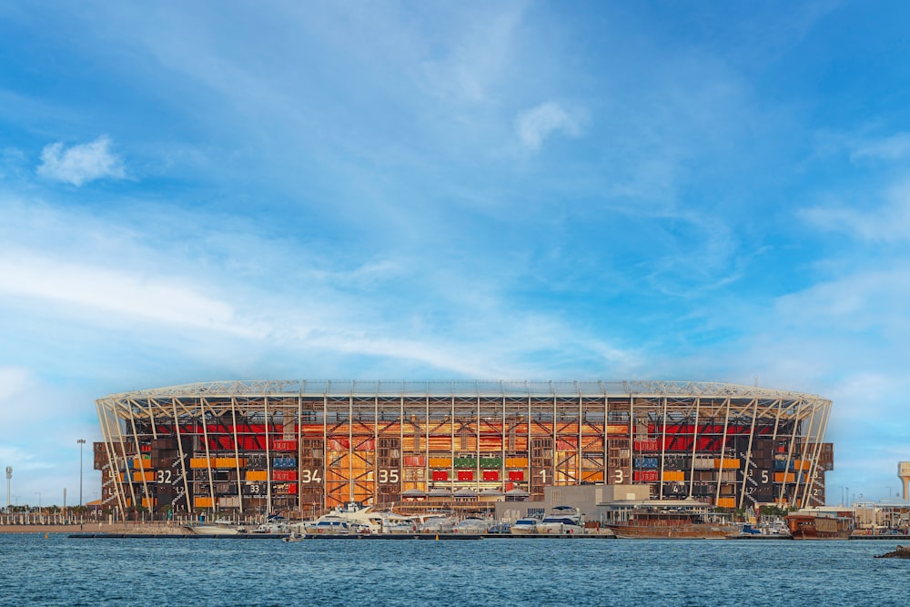 a large building under construction next to a body of water