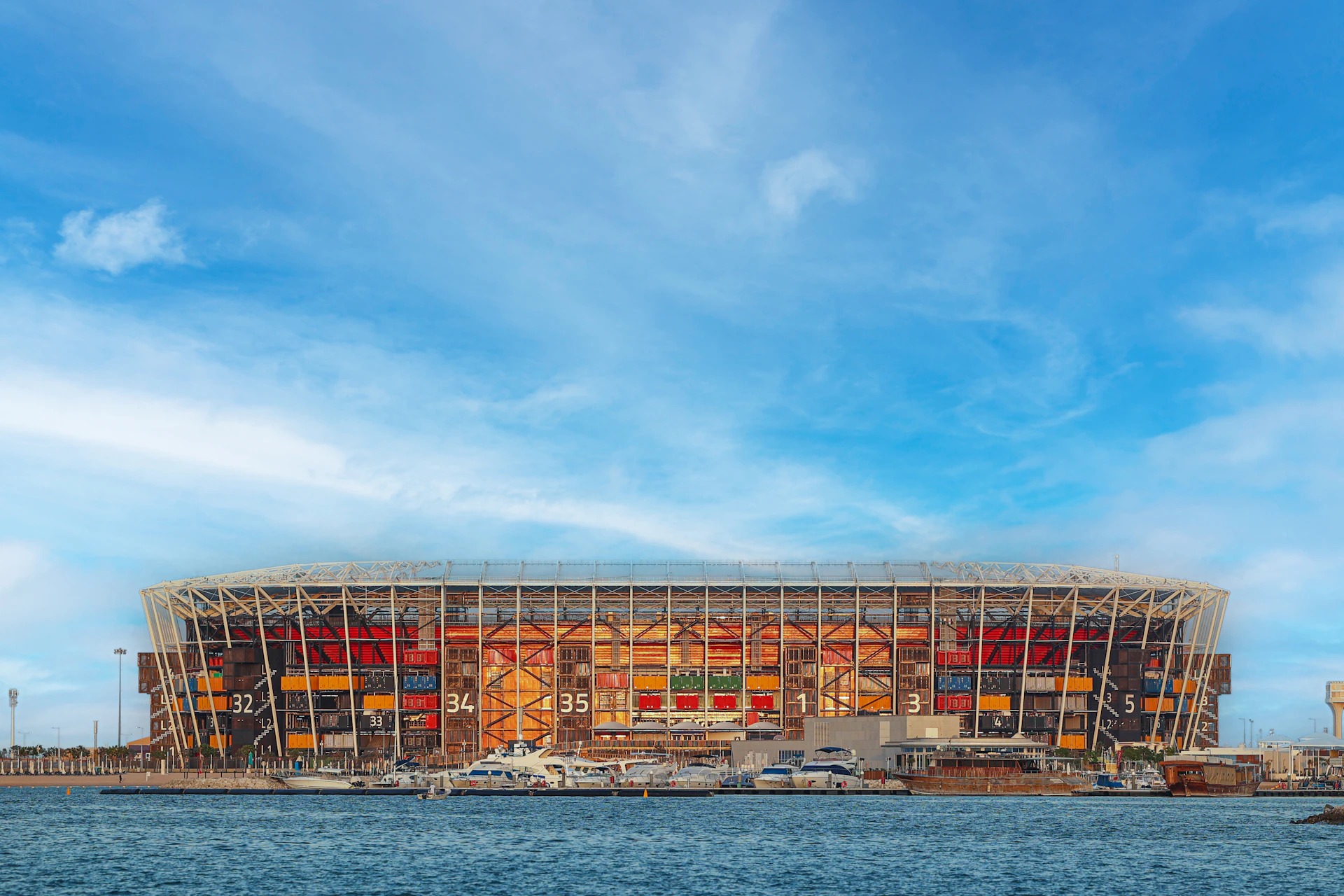 a large building under construction next to a body of water