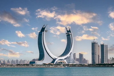 The crescent-shaped Katara Towers rising above the waterfront in Lusail, Qatar
