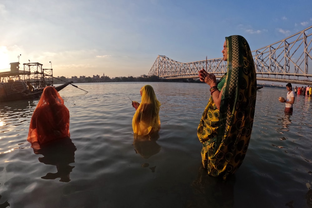 a woman in a sari standing in the water