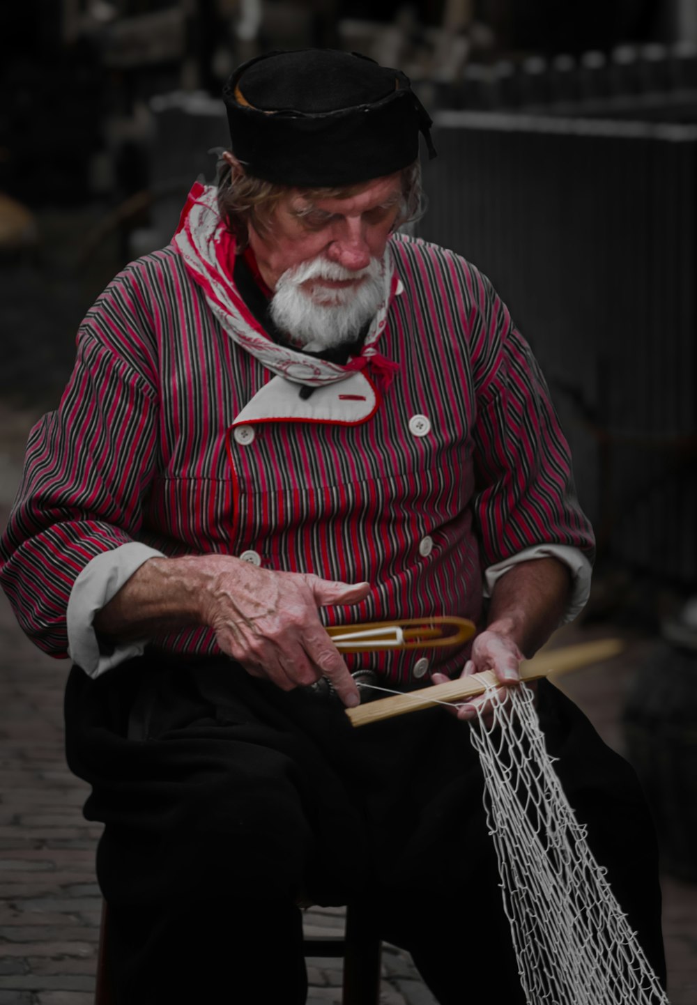 a man sitting on a chair holding a fishing net