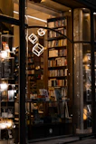 Elegant minimalist bookstore interior with warm lighting and cream-colored walls