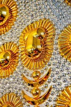 Luxurious black and gold art deco design with bold geometric shapes and sunburst details.