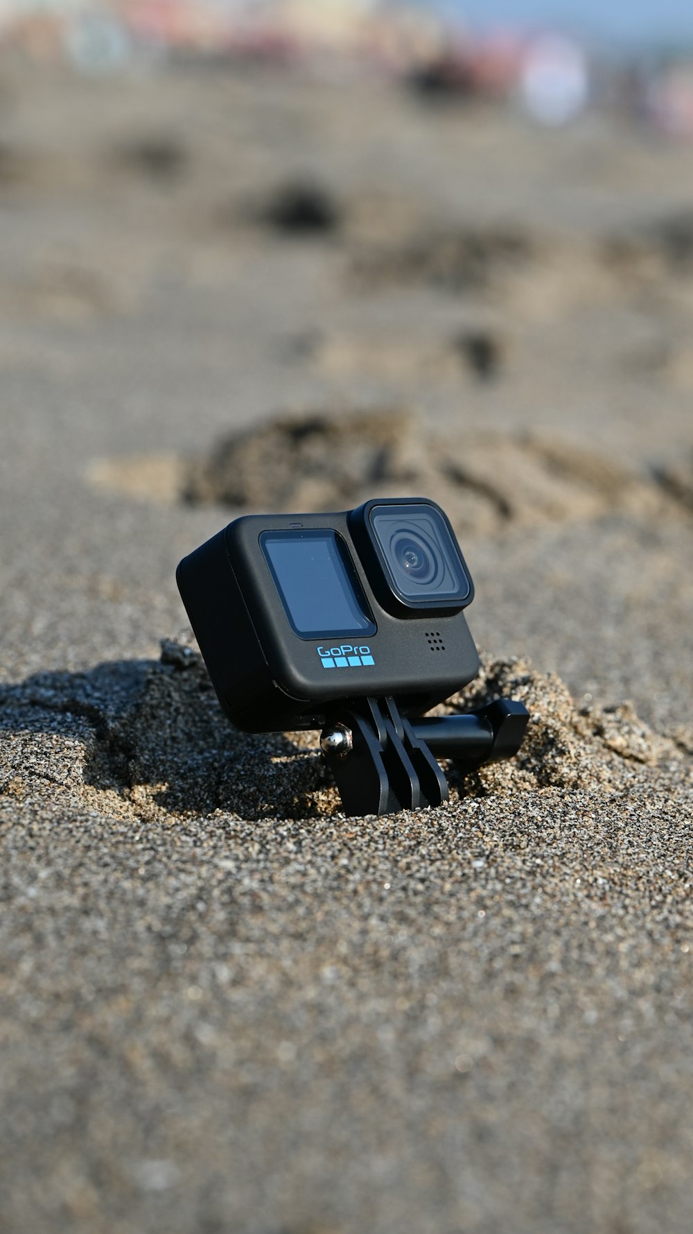 a camera sitting on top of a sandy beach