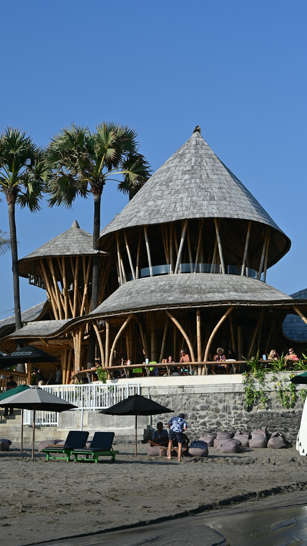 a building with a thatched roof on the beach