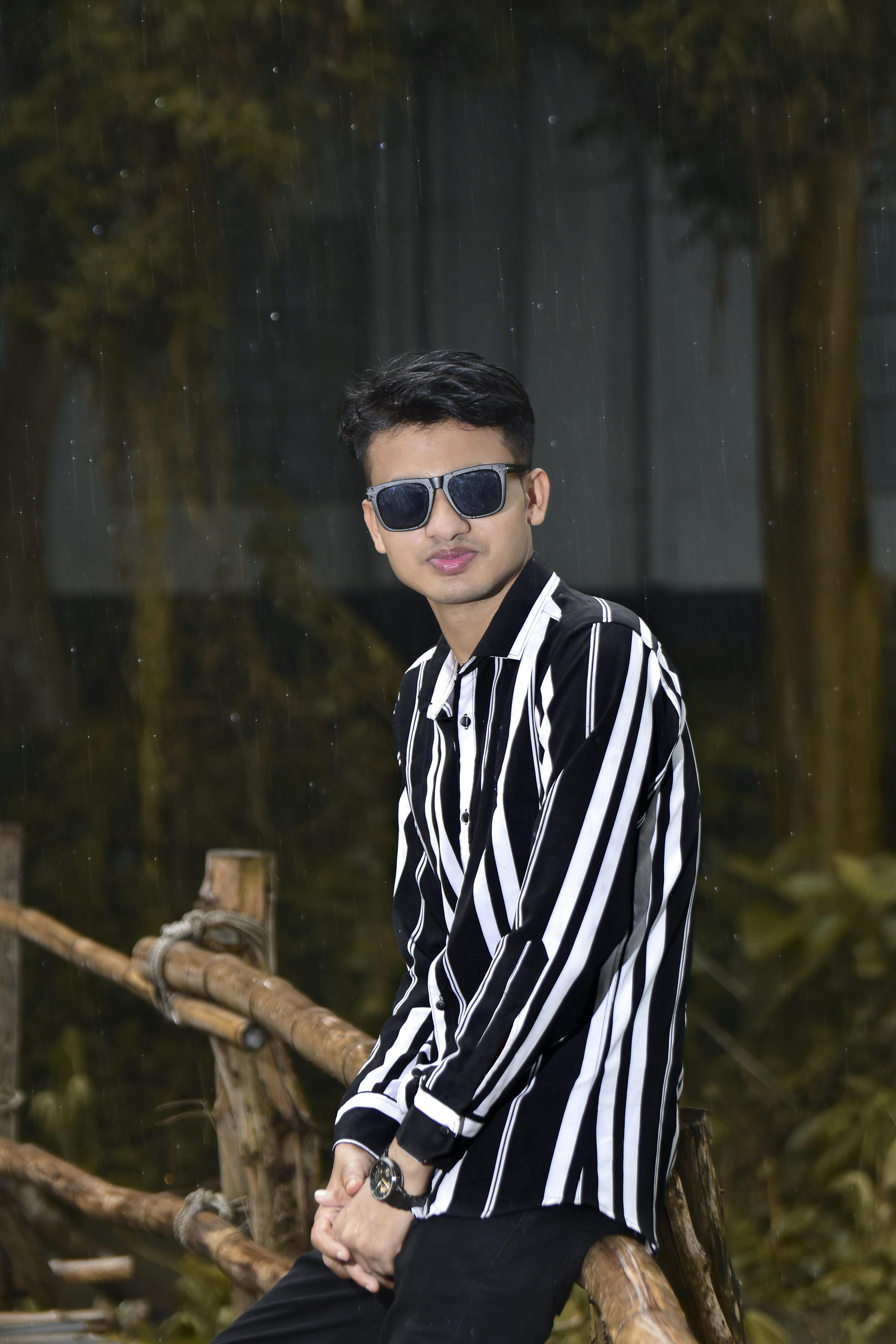 a man in a black and white shirt and sunglasses