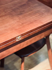 a close up of a wooden table with a drawer