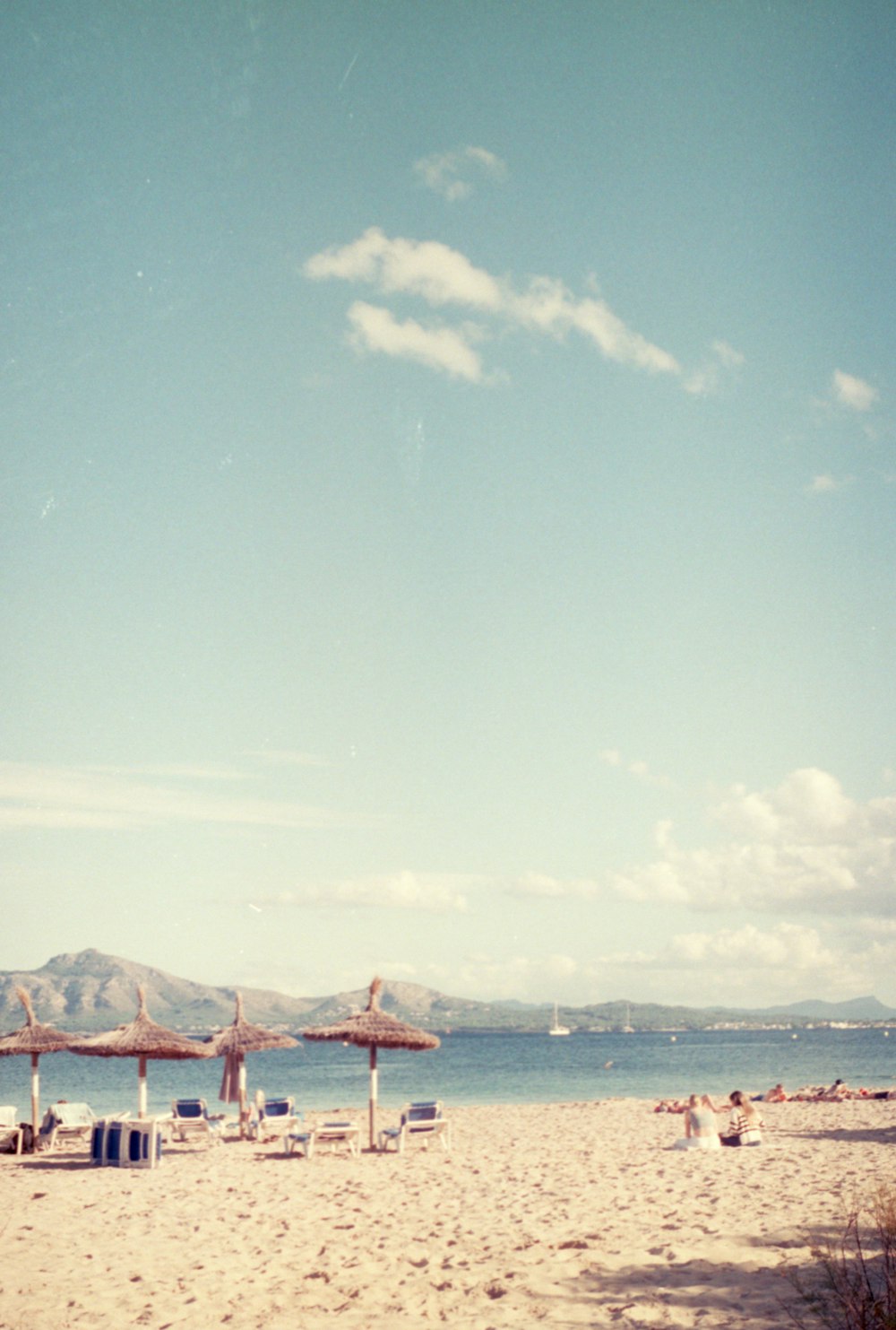 une plage de sable avec des chaises et des parasols