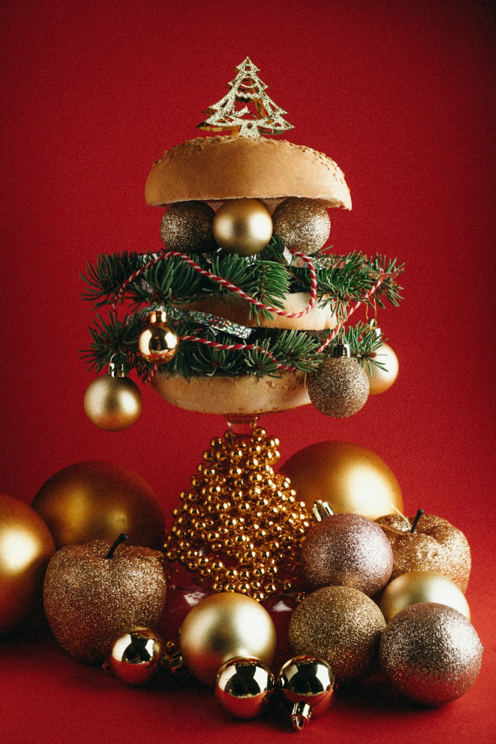 a christmas tree made out of ornaments on a red background