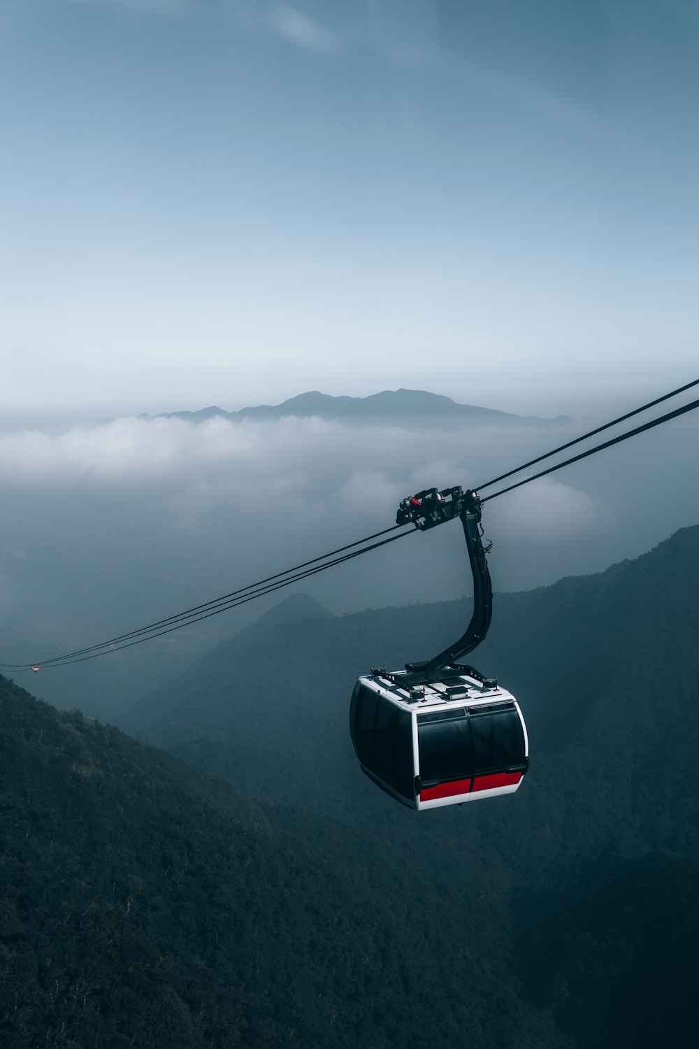 a cable car going up a mountain in the sky