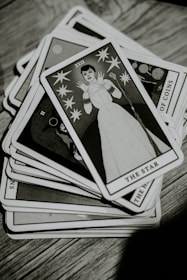 a stack of cards sitting on top of a wooden table